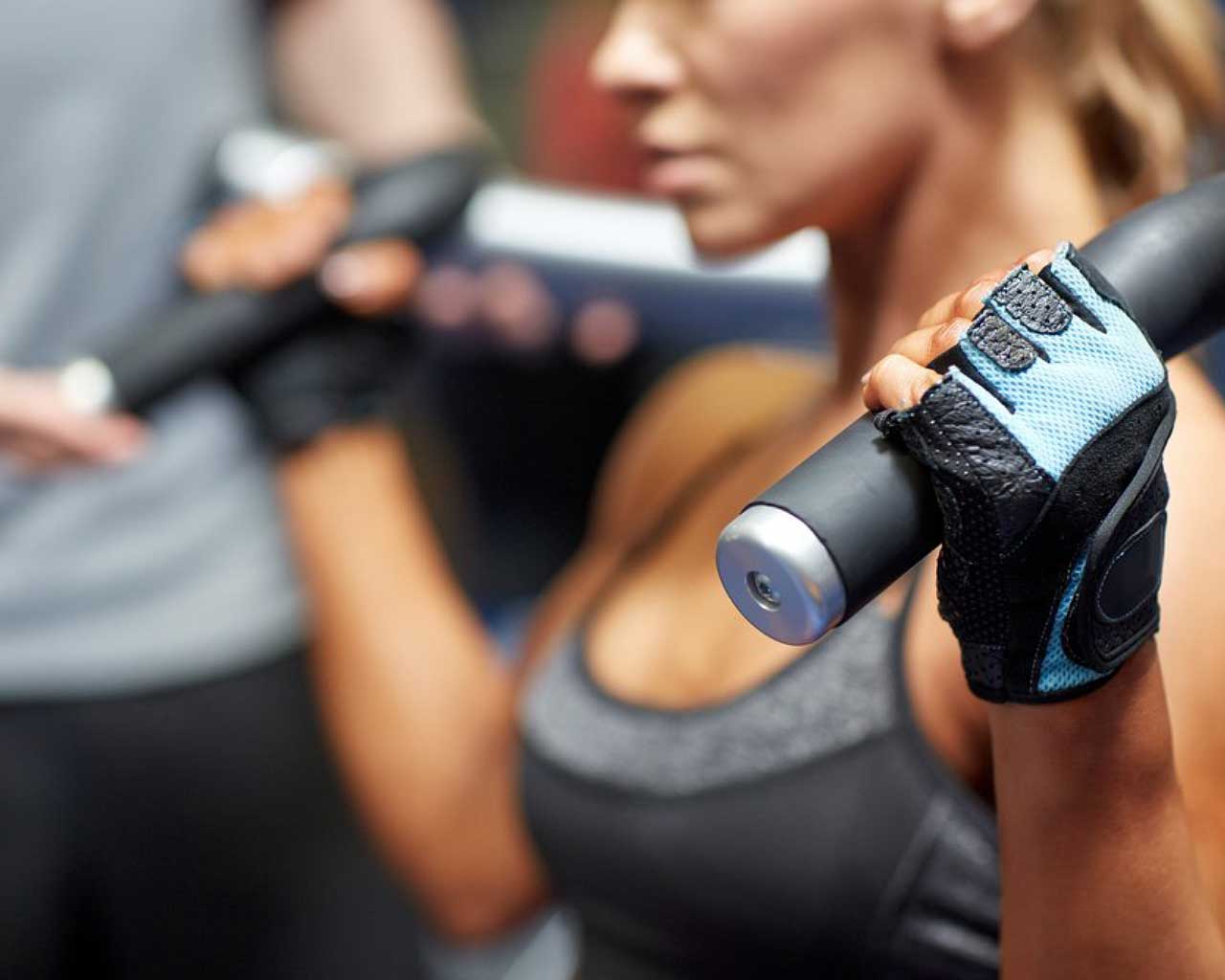 Woman lifting weights with a focus on strength training, showcasing exercise technique relevant to S.E.T. Method™ at Posture Lab LA.
